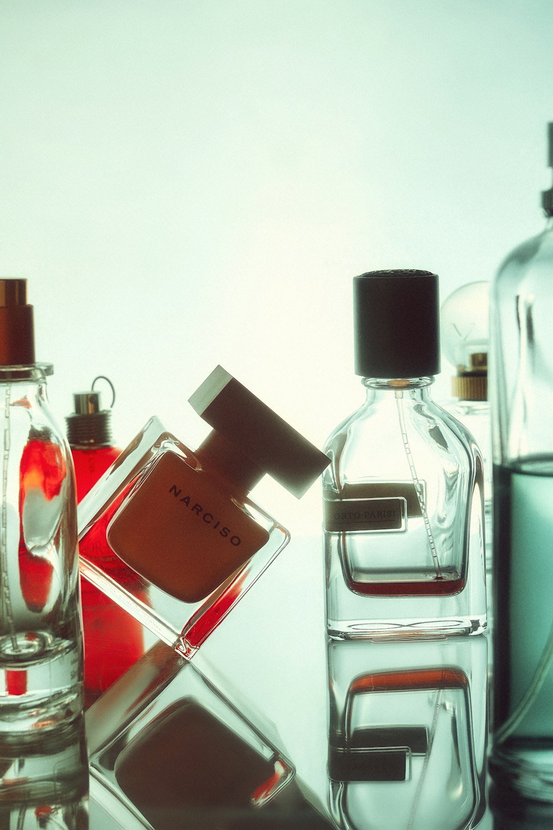 a-table-topped-with-bottles-of-different-types-of-perfume-bylftraijum